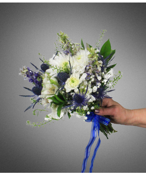 white flowers in small nosegay held in manicured hand