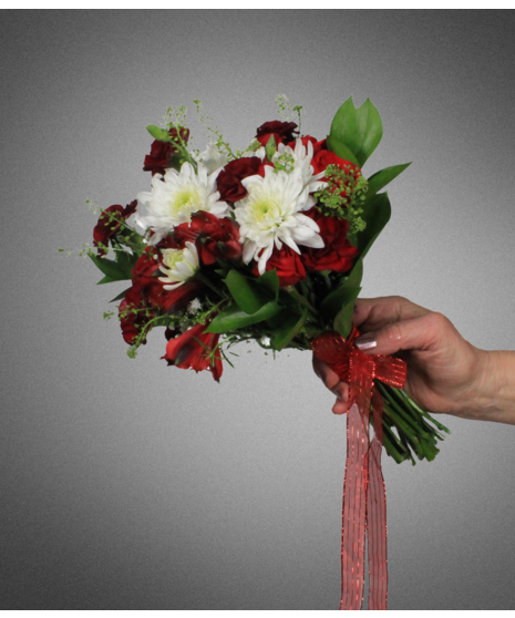 white flowers in small nosegay held in manicured hand